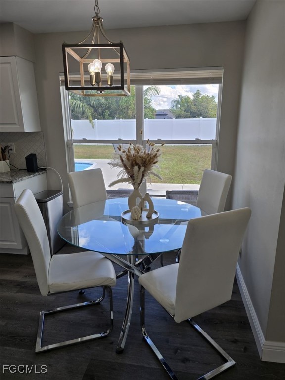 112 Rowland Road Lehigh Acres, FL 33936 - Photo 9 of 31 a view of a dining room with furniture wooden floor and chandelier