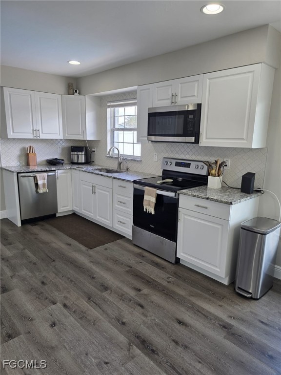 112 Rowland Road Lehigh Acres, FL 33936 - Photo 10 of 31 a kitchen with a sink cabinets and stainless steel appliances
