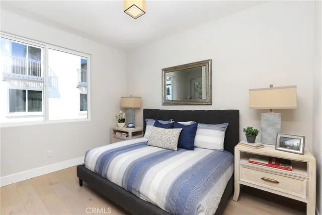 a bedroom with a large bed and a potted plant