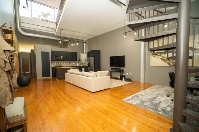 a large bedroom with a bed tv and a window