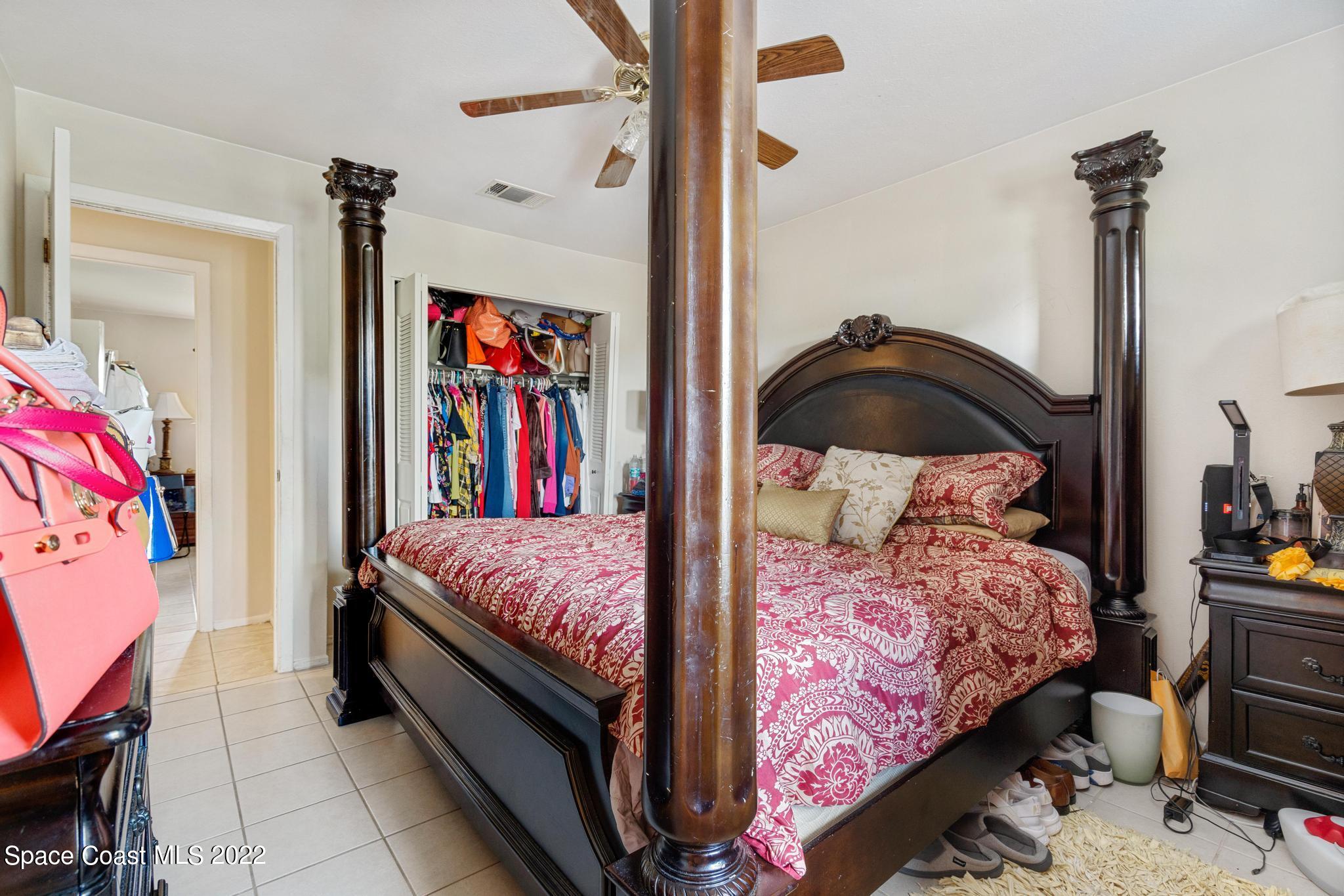 1148 Newbern Street Northeast Palm Bay, FL 32905 - Photo 16 of 38 a bedroom with a bed and wooden floor