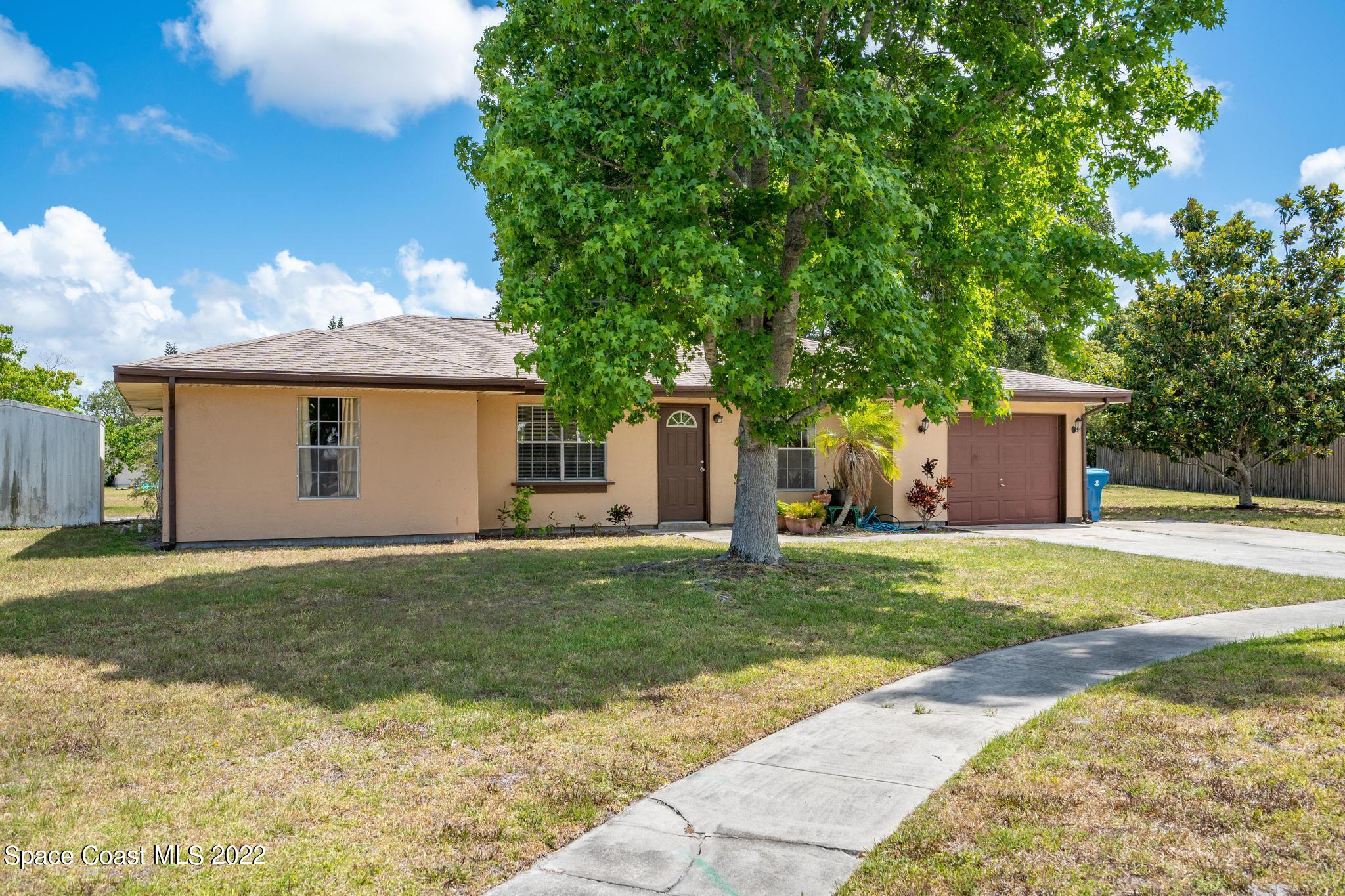 1148 Newbern Street Northeast Palm Bay, FL 32905 - Photo 19 of 38 a view of a house with a yard