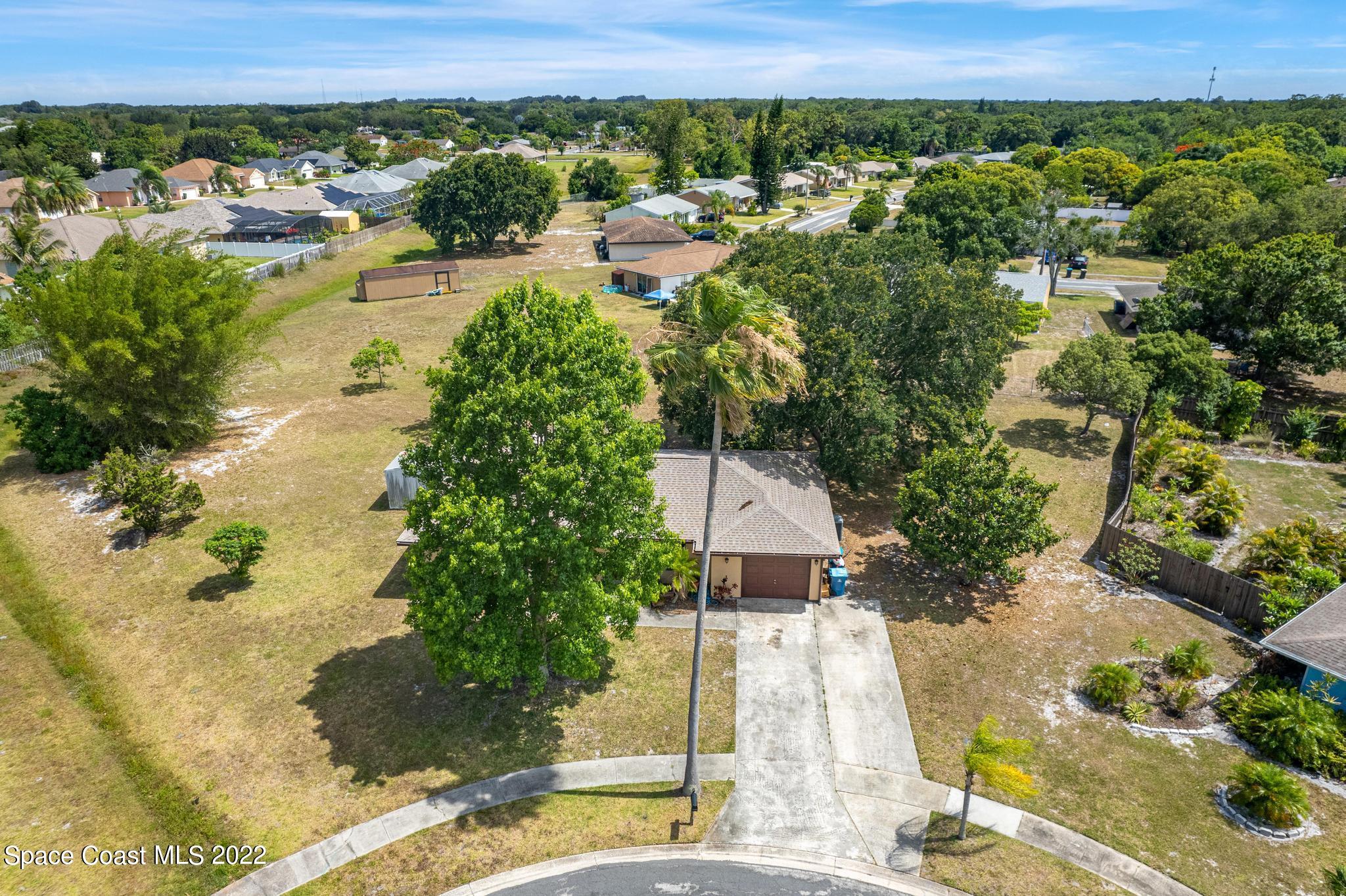 1148 Newbern Street Northeast Palm Bay, FL 32905 - Photo 28 of 38 a view of a lake with a yard