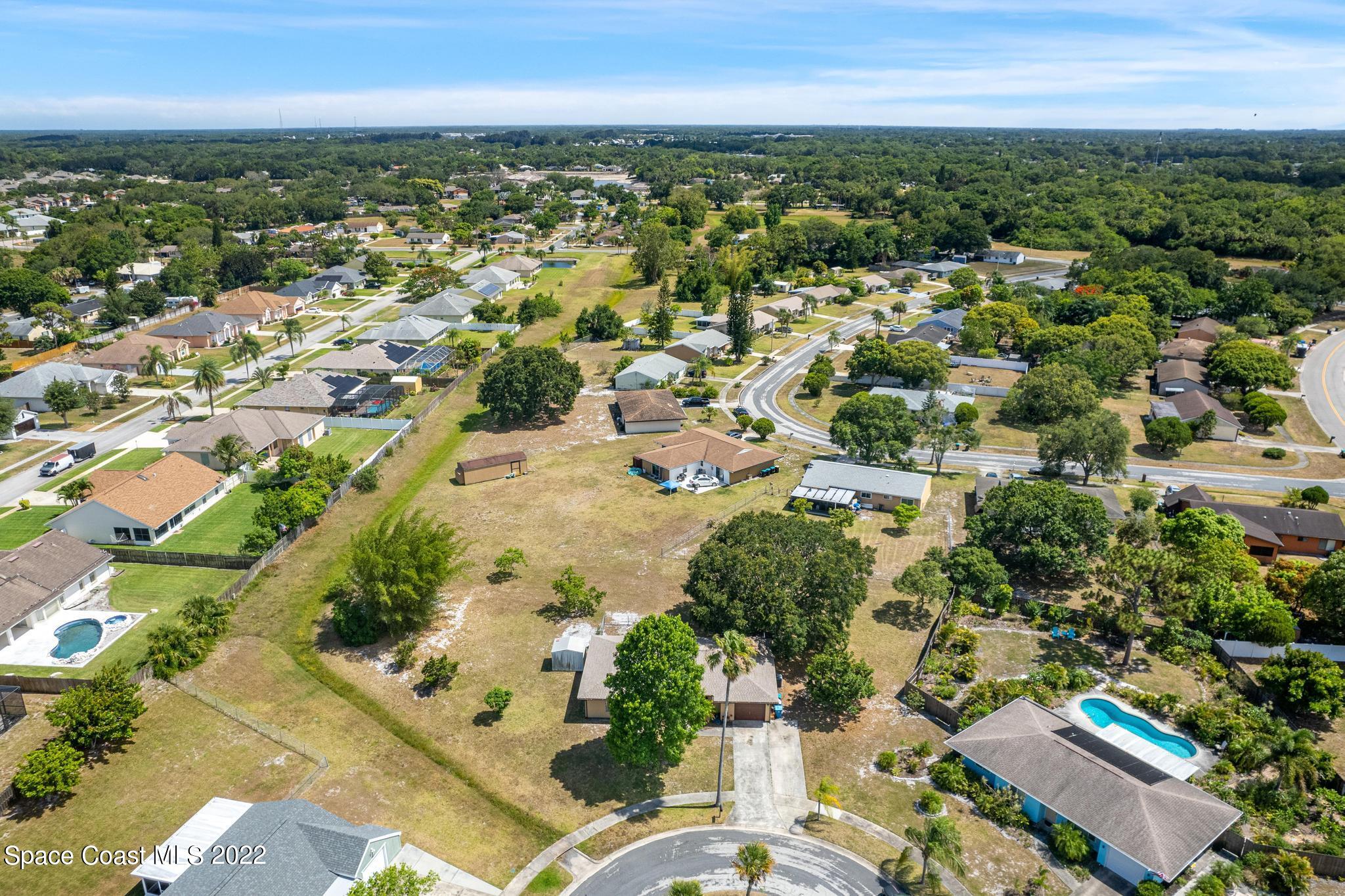 1148 Newbern Street Northeast Palm Bay, FL 32905 - Photo 35 of 38 an aerial view of residential houses with outdoor space