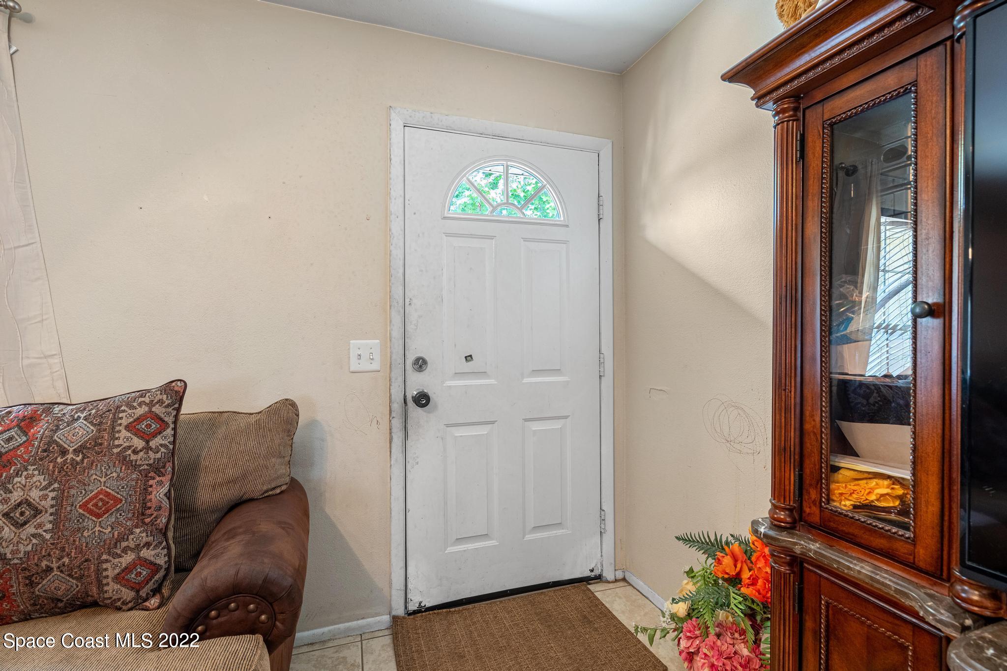 1148 Newbern Street Northeast Palm Bay, FL 32905 - Photo 6 of 38 a living room with furniture and a window