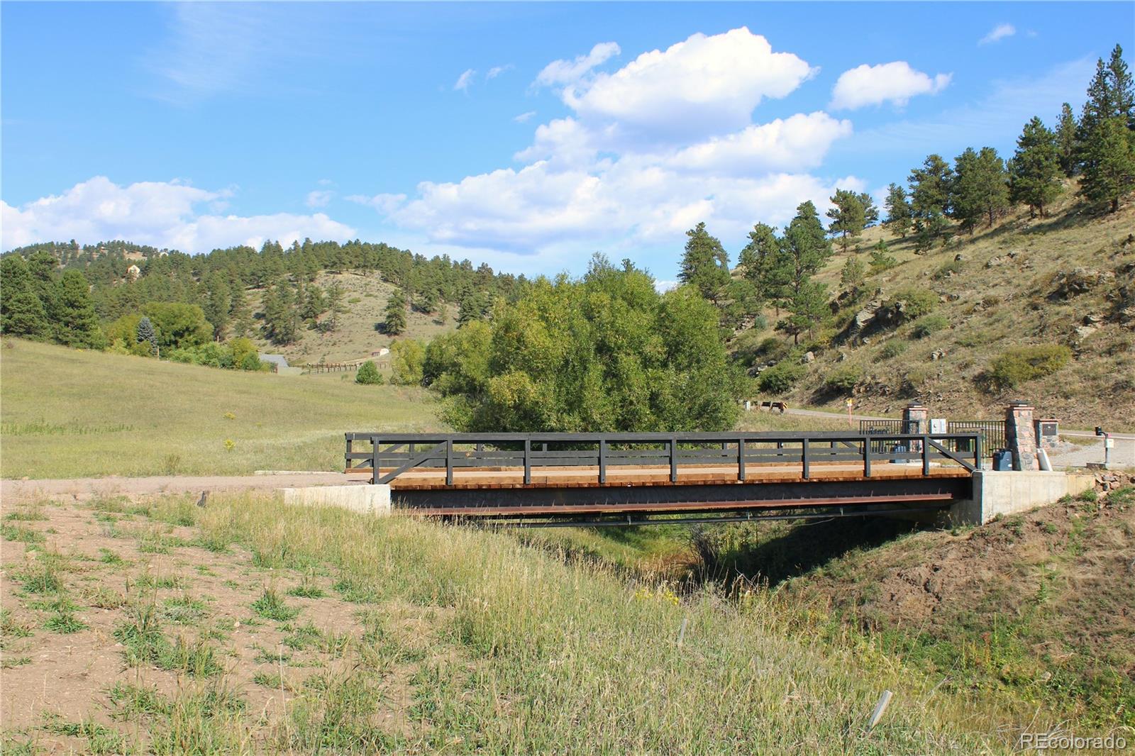 2414 Legacy Ranch Road Evergreen, CO 80439 - Photo 13 of 16 a view of a lake with a mountain