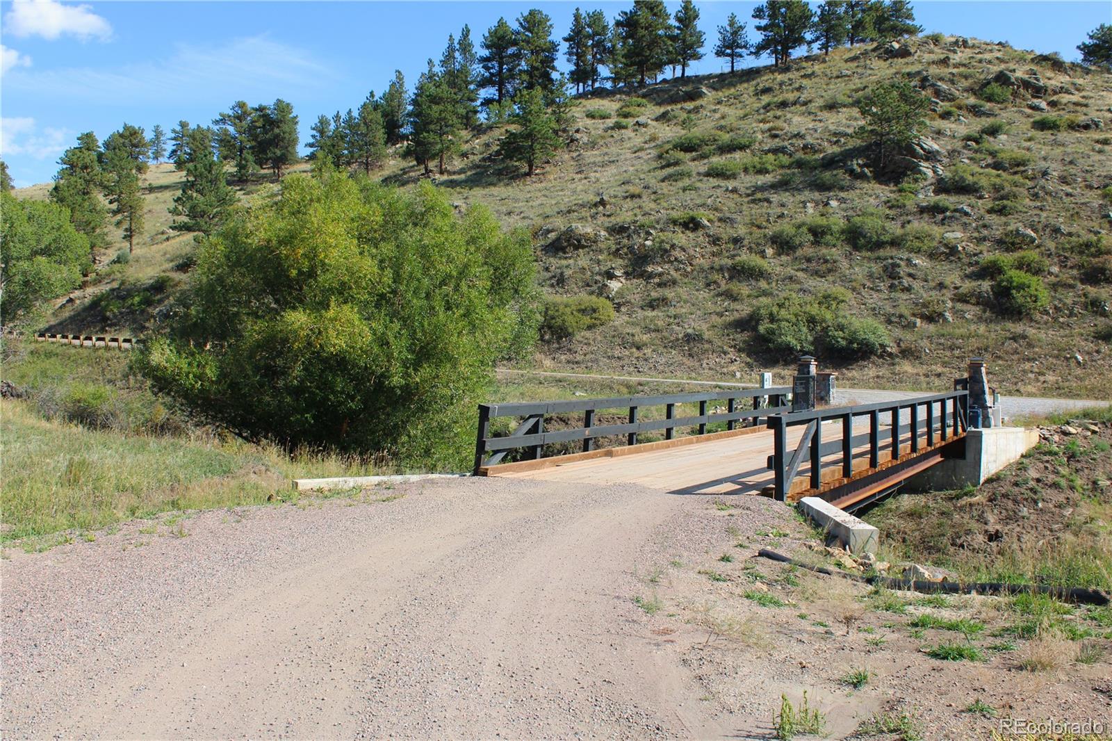 2414 Legacy Ranch Road Evergreen, CO 80439 - Photo 14 of 16 a view of a house with a yard