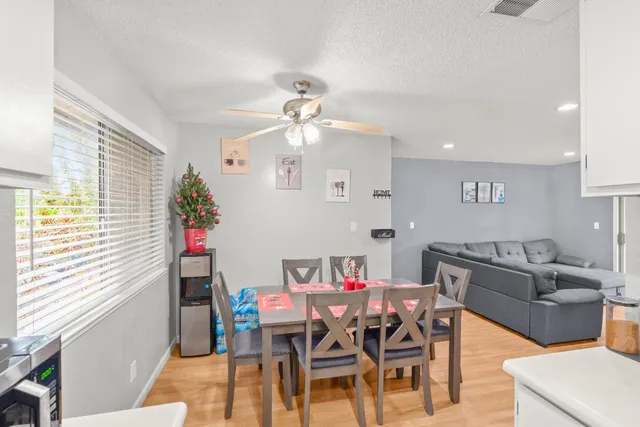 a view of a dining room with furniture and a window