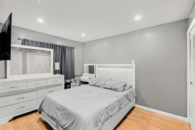 a bedroom with a bed and a flat screen tv