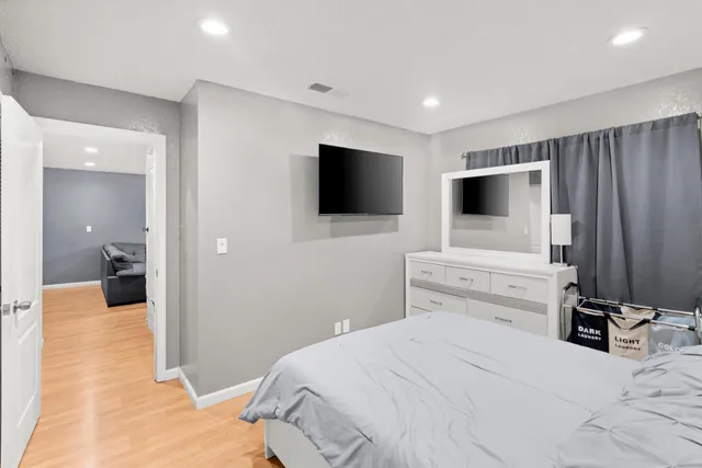 a bedroom with a bed and a flat screen tv