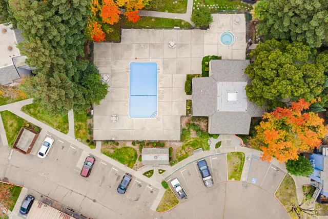 an aerial view of a house with a yard and swimming pool
