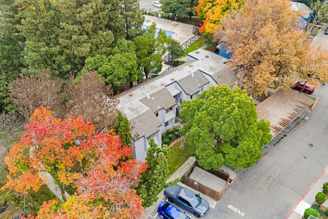 an aerial view of a house with a yard