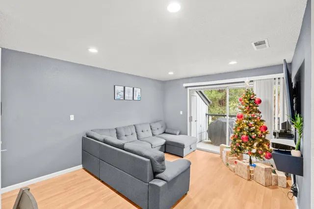 a living room with furniture and flowers
