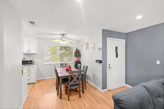 a view of a dining room with furniture and wooden floor