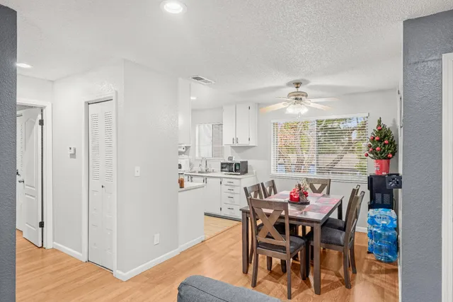 a view of a dining room with furniture and a chandelier