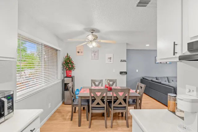 a view of a dining room with furniture and chandelier