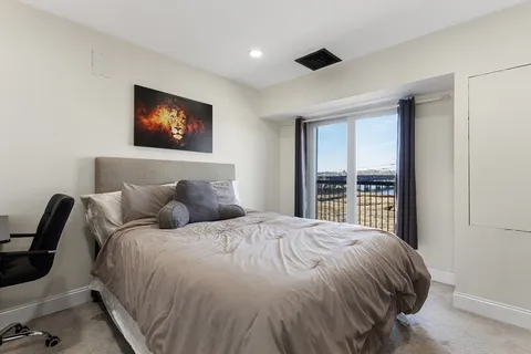 a bedroom with a large bed and a window