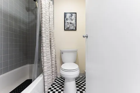 a bathroom with a toilet and a bathtub