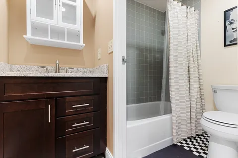 a bathroom with a sink a toilet and a bathtub