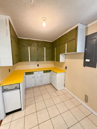 a view of a kitchen with fridge and window