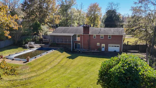 a view of a house with a yard patio and fire pit