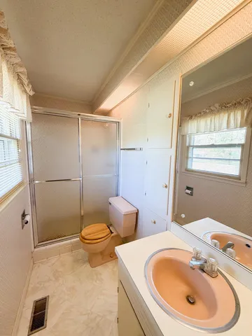 a bathroom with a sink toilet and shower