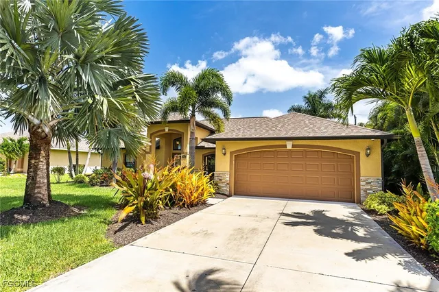 a front view of a house with a yard and a garage