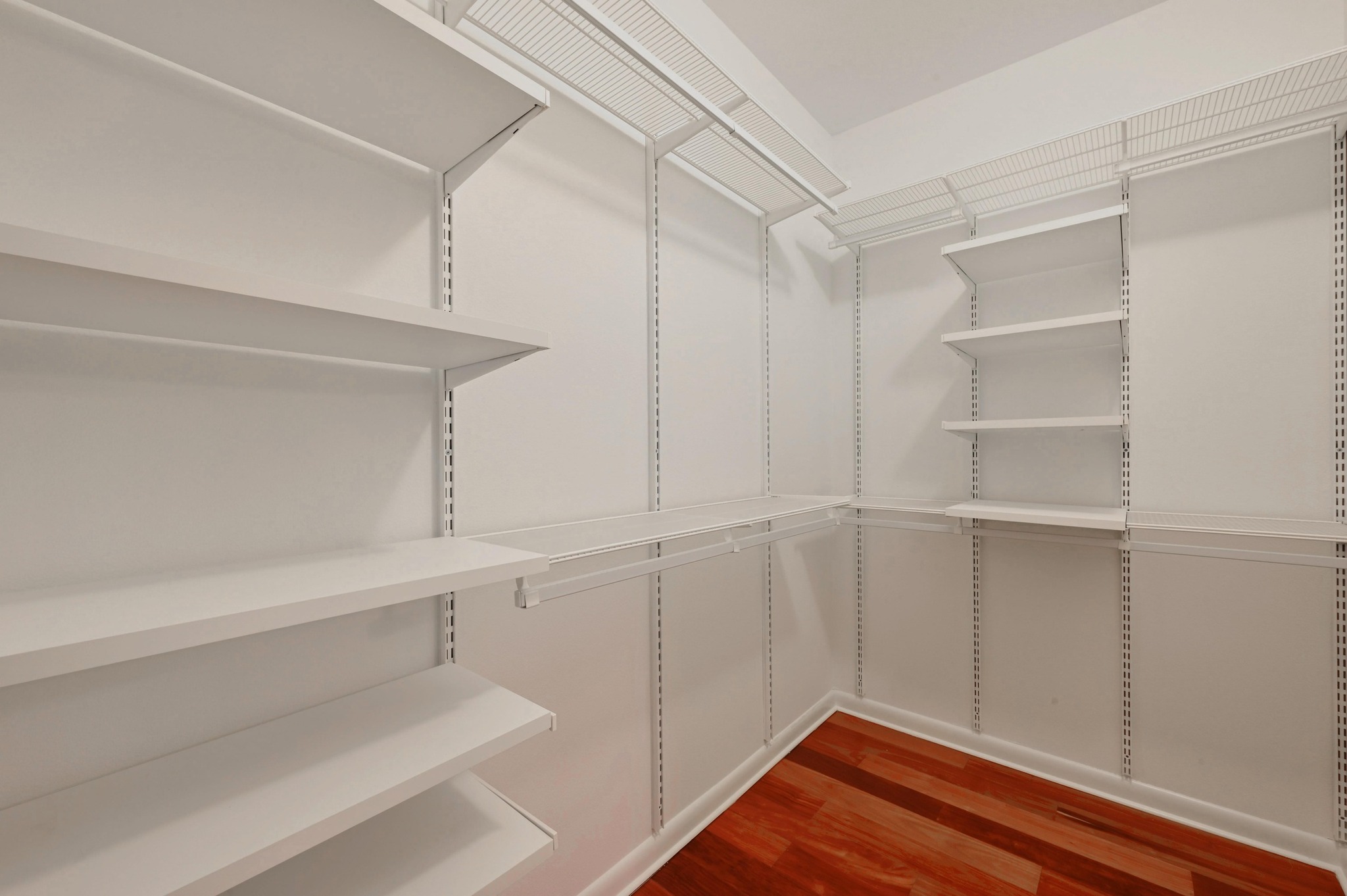 54 Rainey Street, Unit 412 Austin, TX 78701 - Photo 16 of 37 Walk in closet with dark wood-style floors