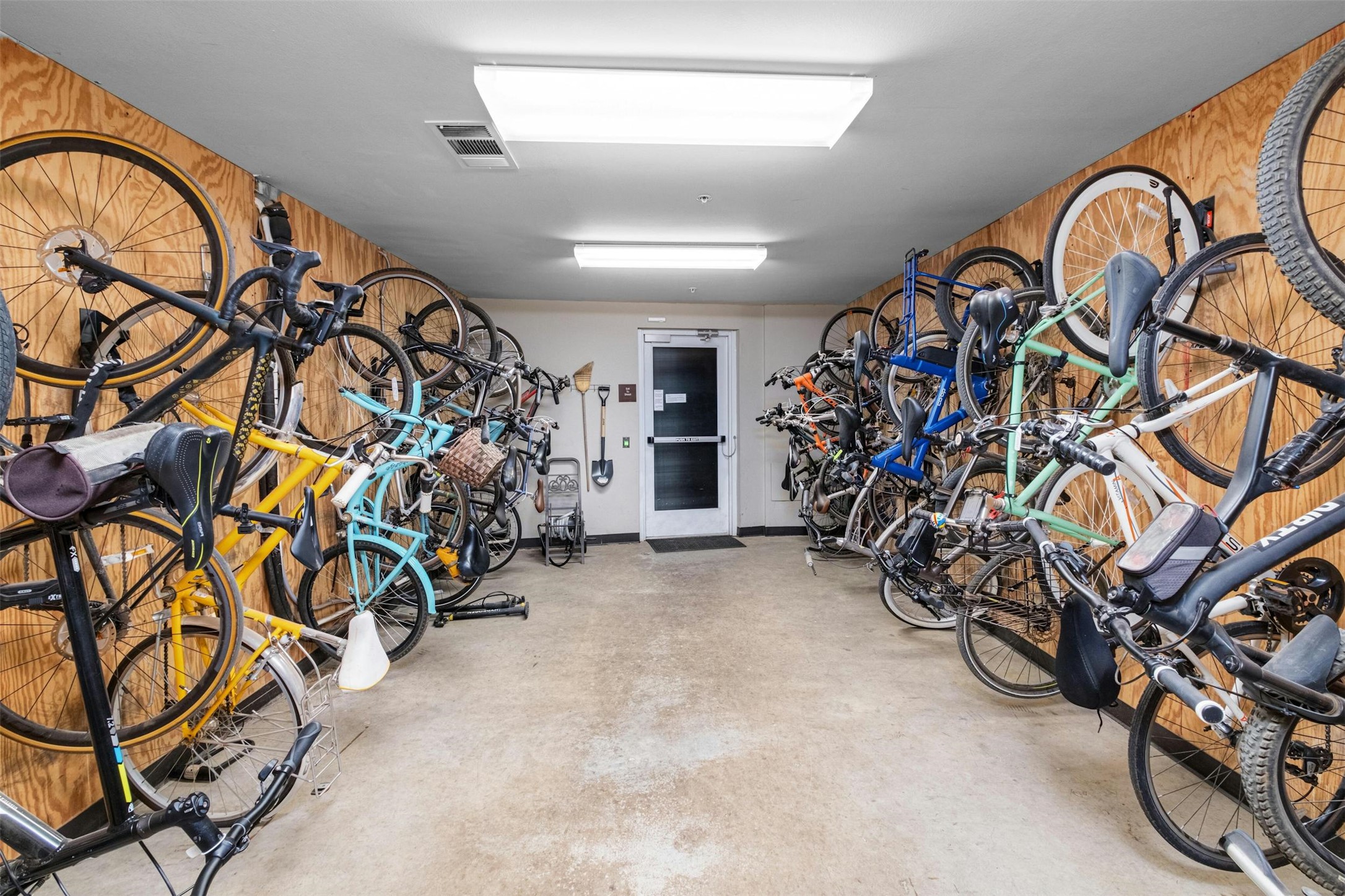 54 Rainey Street, Unit 412 Austin, TX 78701 - Photo 26 of 37 Bike storage and wooden walls
