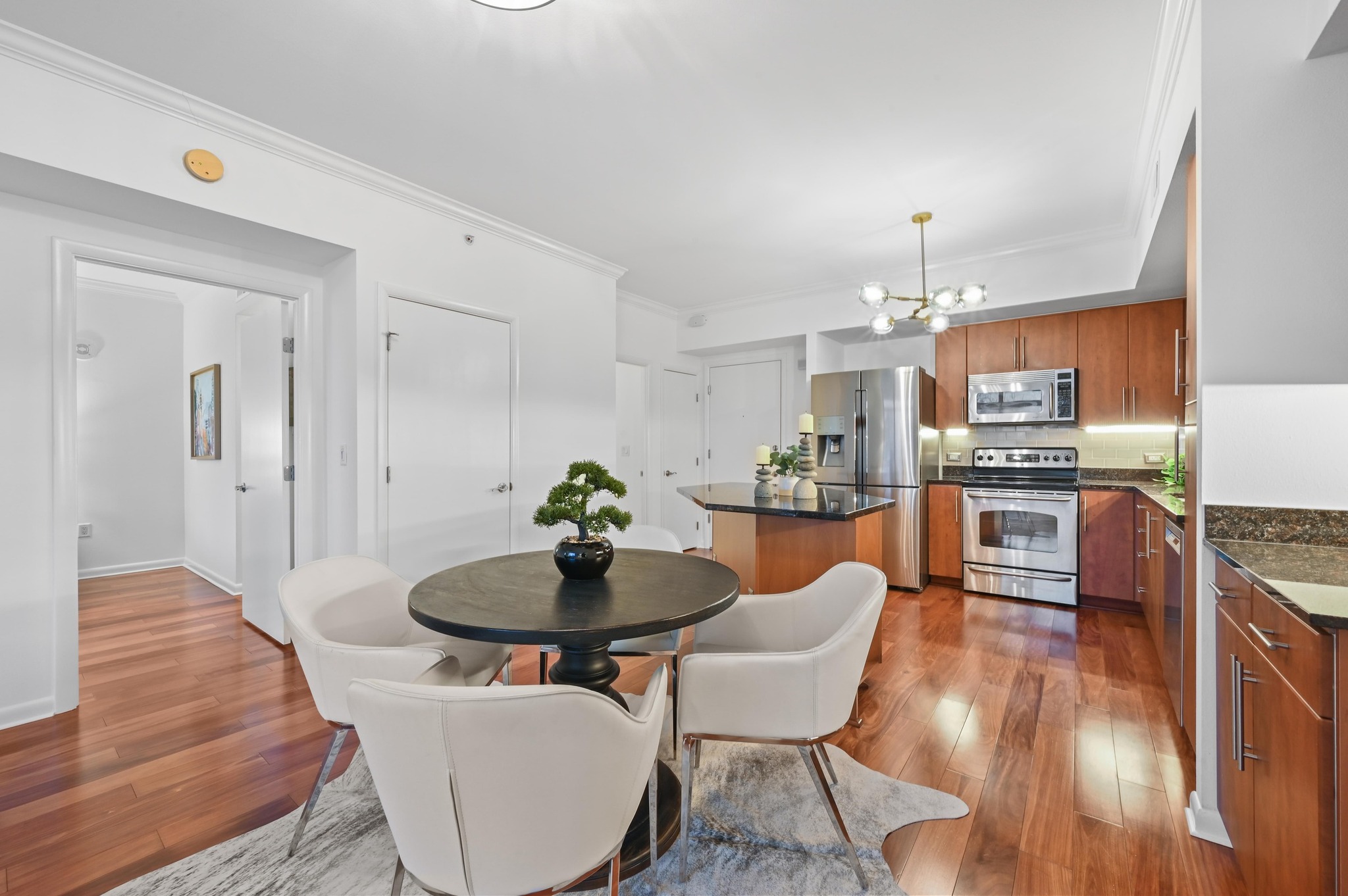 54 Rainey Street, Unit 412 Austin, TX 78701 - Photo 7 of 37 Dining area featuring crown molding, wood flooring