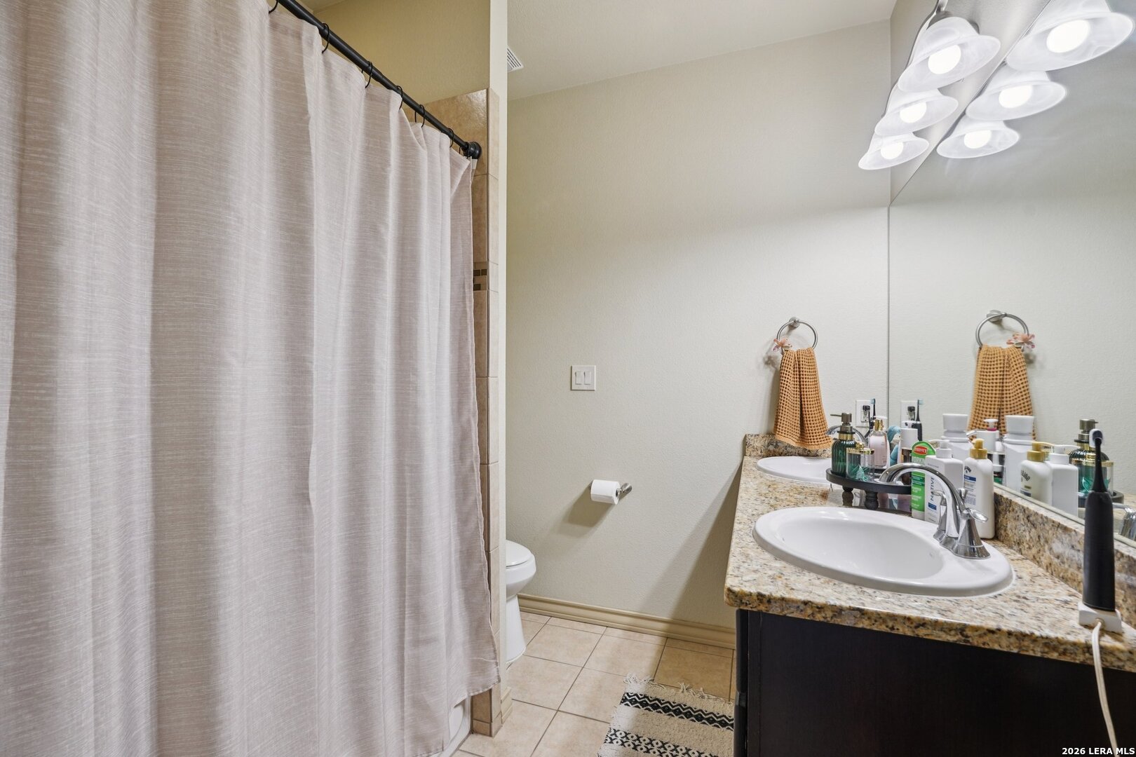 2312 Sailing Way, Unit B Kerrville, TX 78028 - Photo 18 of 25 a bathroom with a granite countertop sink and a mirror