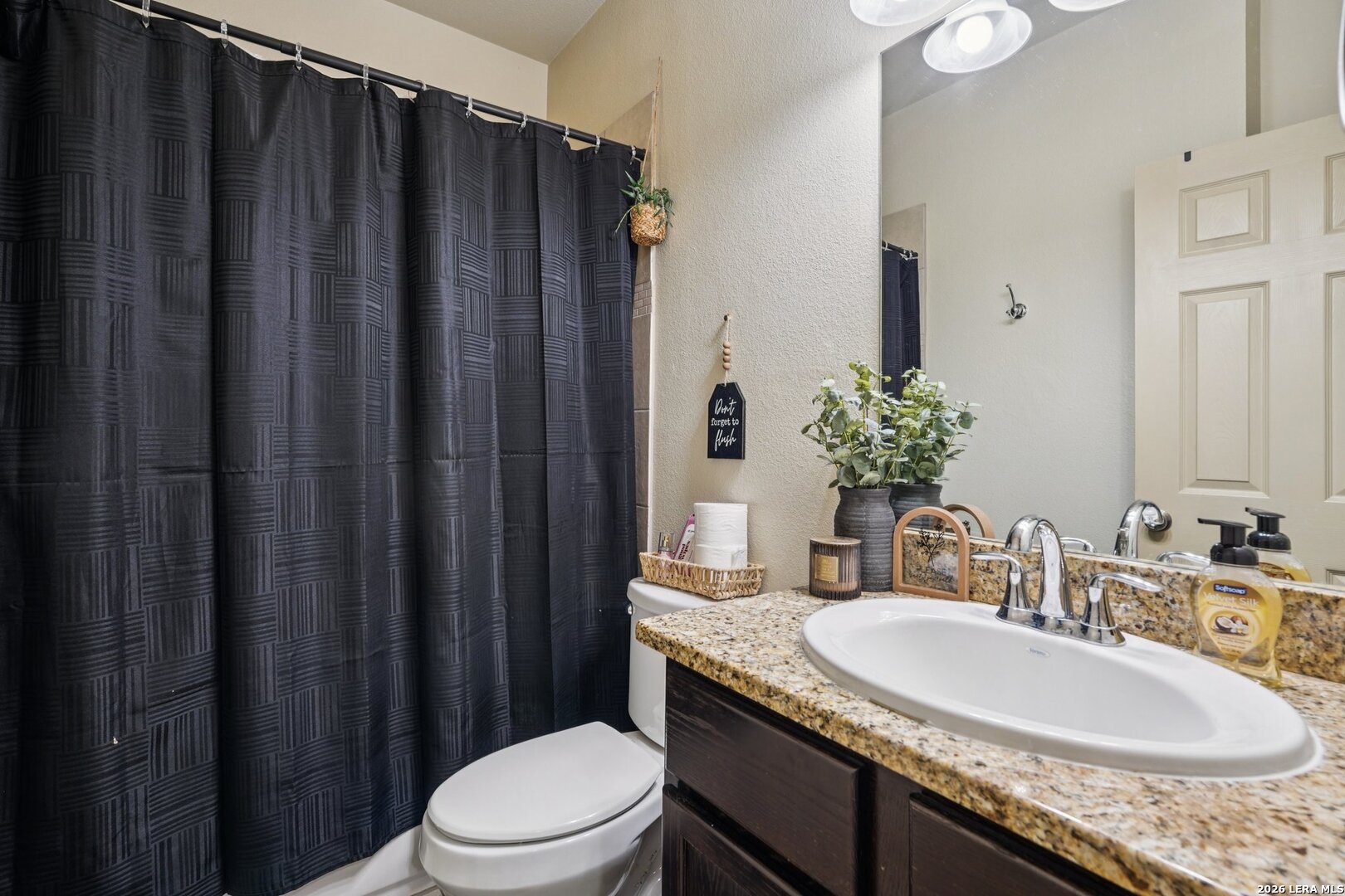 2312 Sailing Way, Unit B Kerrville, TX 78028 - Photo 21 of 25 a bathroom with a granite countertop sink toilet and mirror