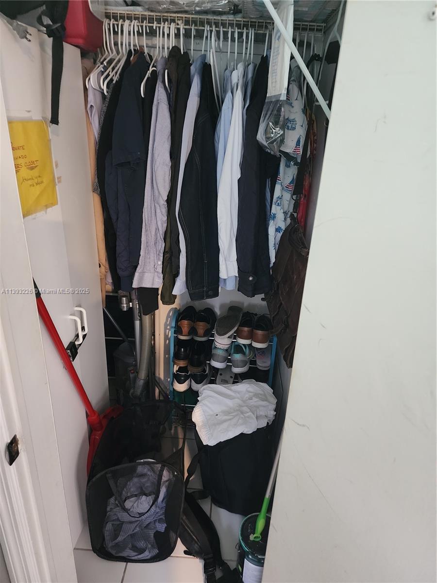 3801 Indian Creek Drive, Unit 201 Miami Beach, FL 33140 - Photo 20 of 27 a view of walk in closet with clothes and shoes