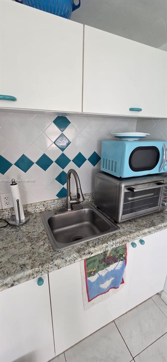 3801 Indian Creek Drive, Unit 201 Miami Beach, FL 33140 - Photo 24 of 27 a close view of sink and stove