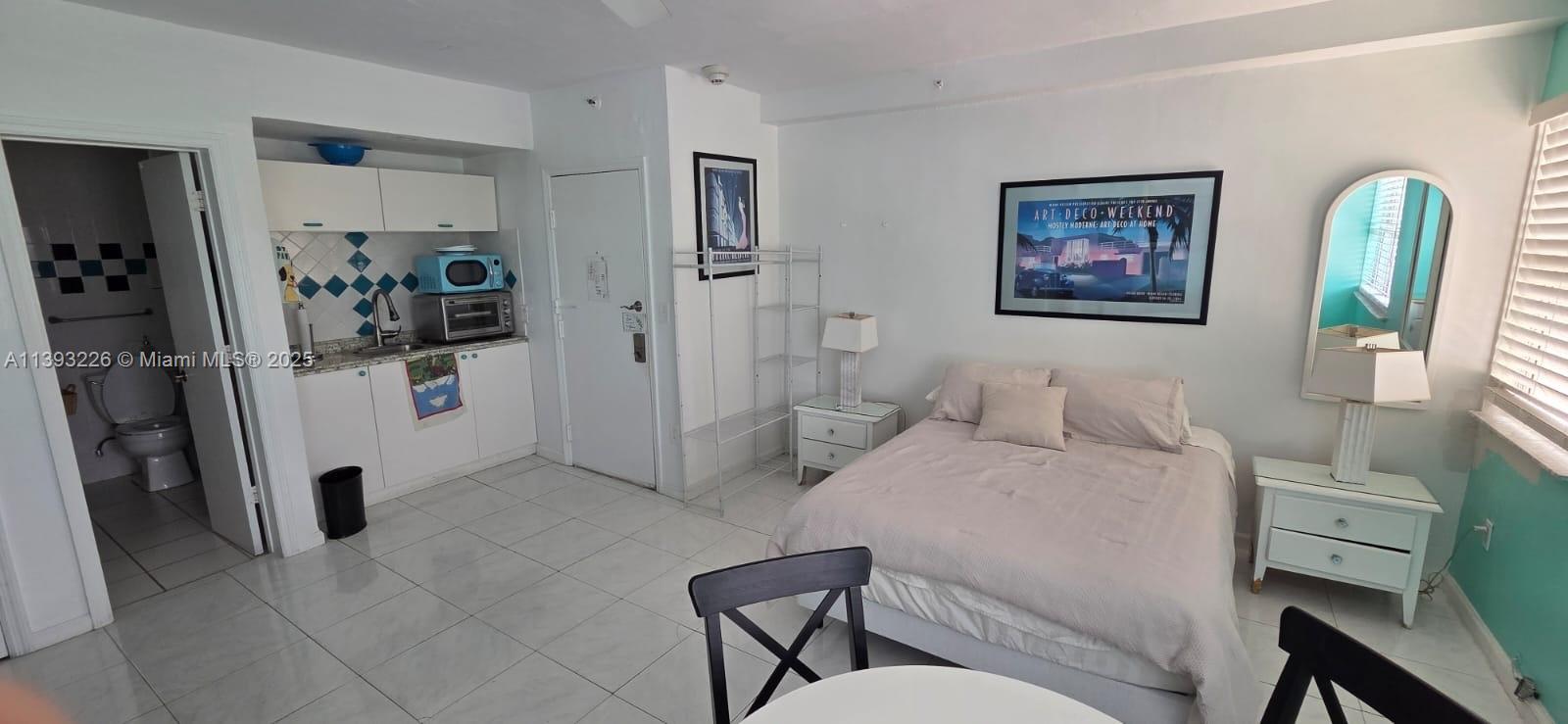 3801 Indian Creek Drive, Unit 201 Miami Beach, FL 33140 - Photo 26 of 27 a bedroom with a bed and a view of bathroom