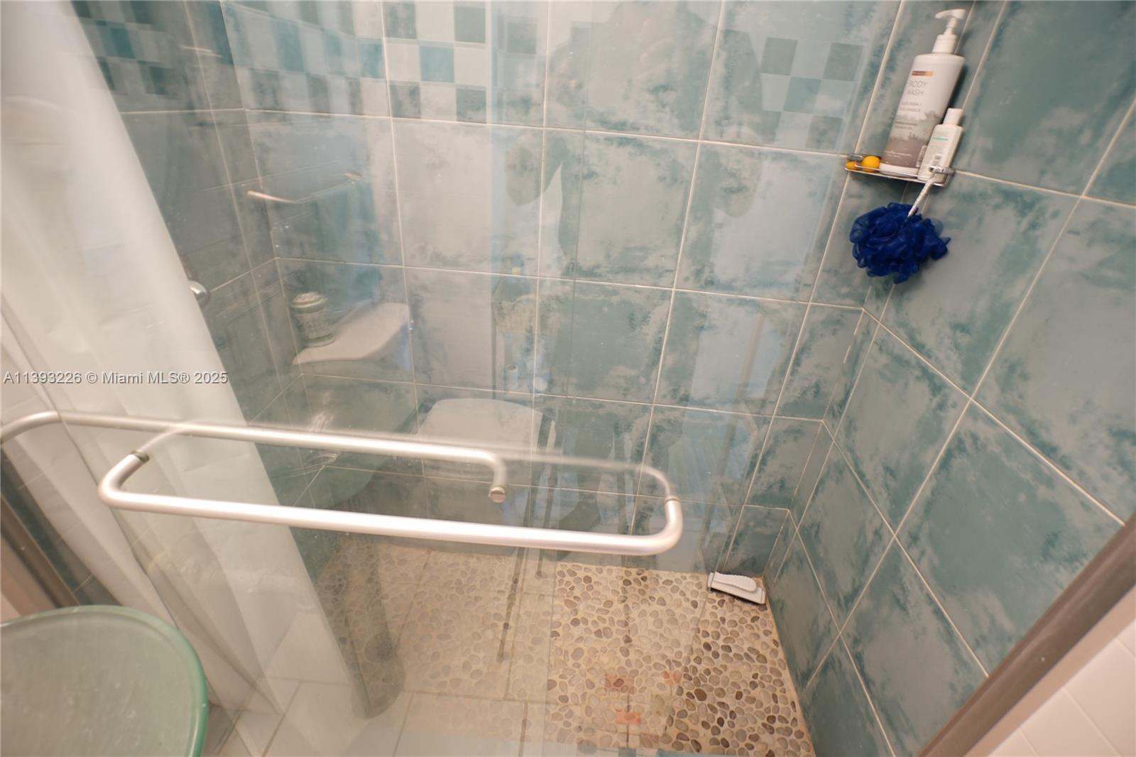 3801 Indian Creek Drive, Unit 201 Miami Beach, FL 33140 - Photo 10 of 27 a bath tub sitting next to a shower