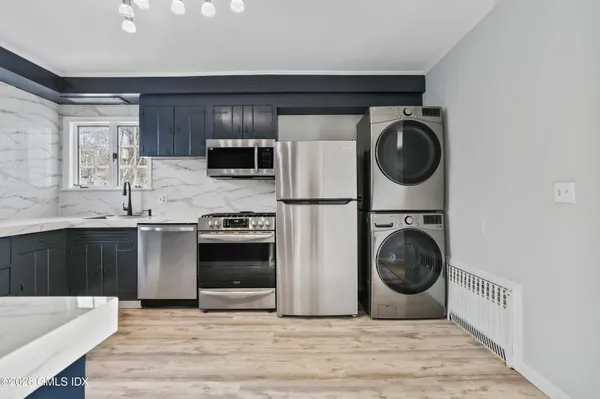 a kitchen with a stove top oven sink and cabinets