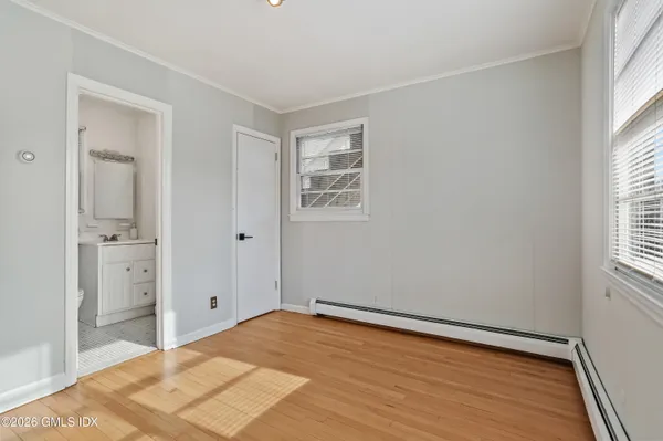 a view of a room with wooden floor and windows