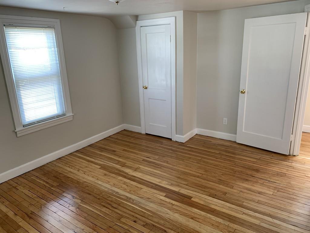 86 Russell Street Springfield, MA 01104 - Photo 17 of 23 a view of empty room with wooden floor and fan