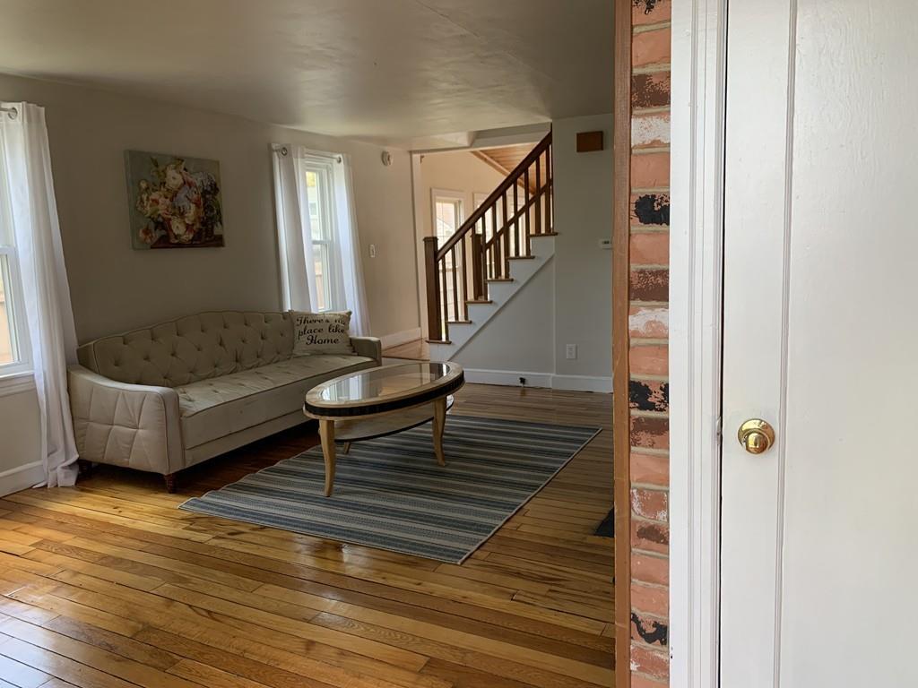 86 Russell Street Springfield, MA 01104 - Photo 4 of 23 a living room with furniture and a wooden floor