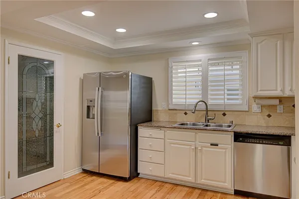 a kitchen with stainless steel appliances granite countertop a refrigerator sink and cabinets