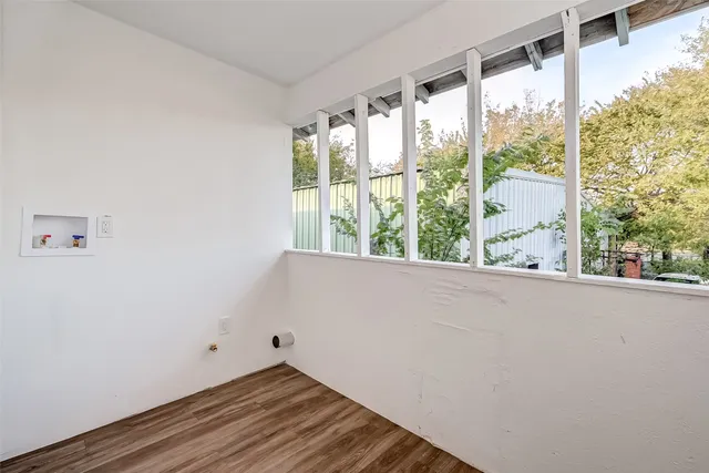 a view of a room with wooden floor and windows