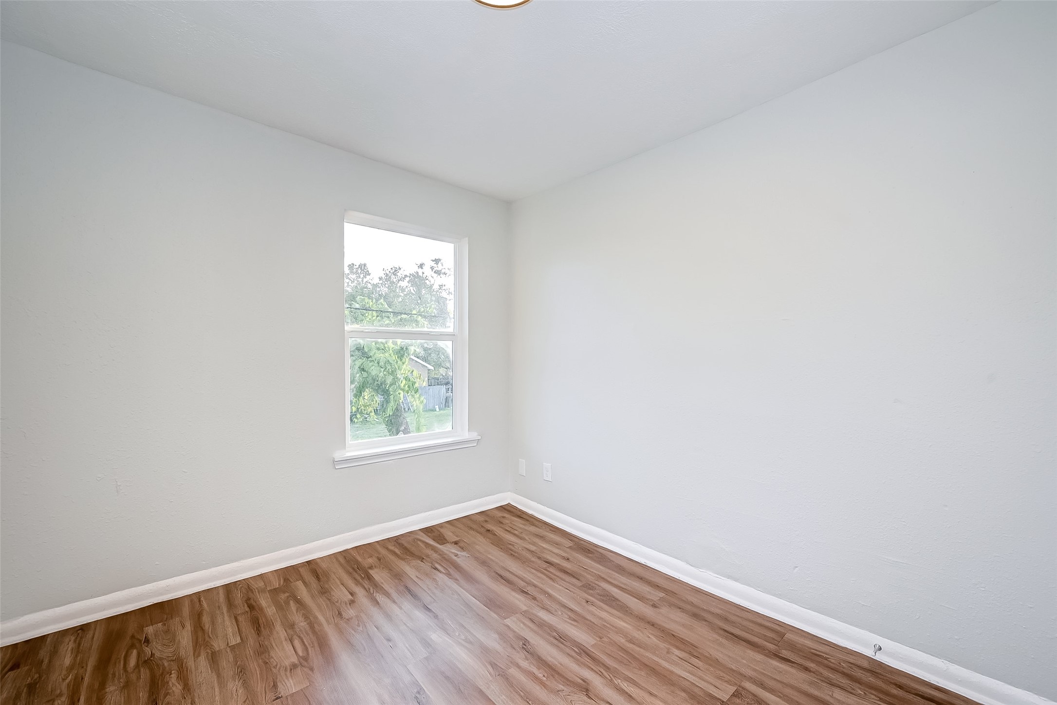 6420 Conley Street, Unit 3 Houston, TX 77021 - Photo 7 of 10 an empty room with wooden floor and windows