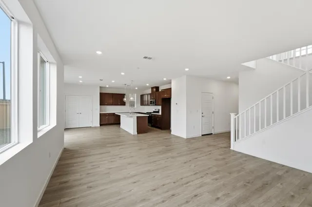 a kitchen with stainless steel appliances granite countertop a sink a stove and a refrigerator