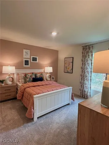 a bedroom with a bed and a night stand