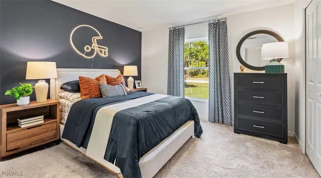 a bedroom with a bed and a painting on the wall