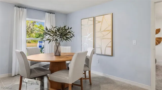 a view of a dining room with furniture and window