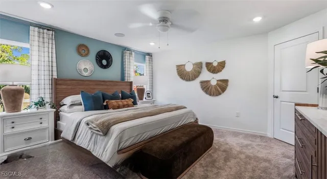 a bedroom with a bed and painting on the wall