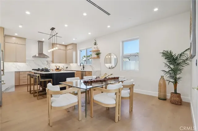 a kitchen with kitchen island granite countertop a sink stainless steel appliances and cabinets