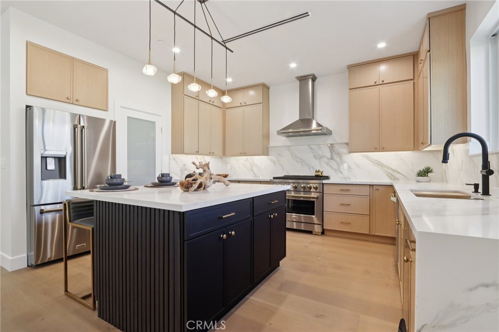 14929 Vose Street Van Nuys, CA 91405 - Photo 12 of 56 a kitchen with kitchen island granite countertop a sink stainless steel appliances and cabinets